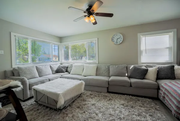 a living room with furniture a bed and a chandelier