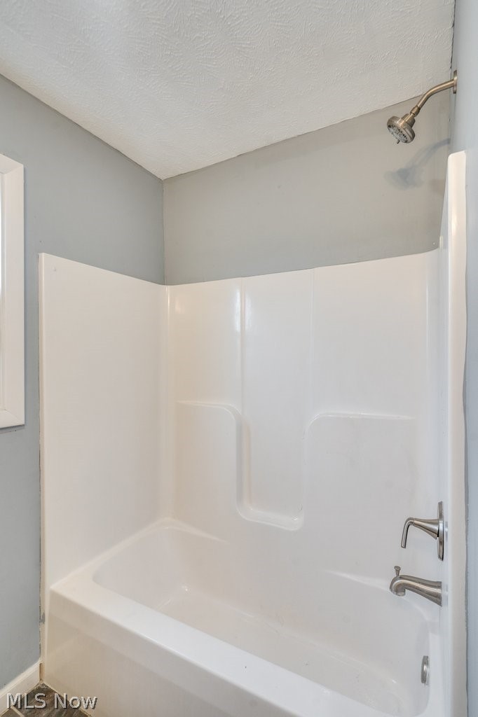 1607 9th Street Southwest Canton, OH 44706 - Photo 30 of 41 Bathtub and shower combination unit featuring a brushed nickel showerhead and bath faucet