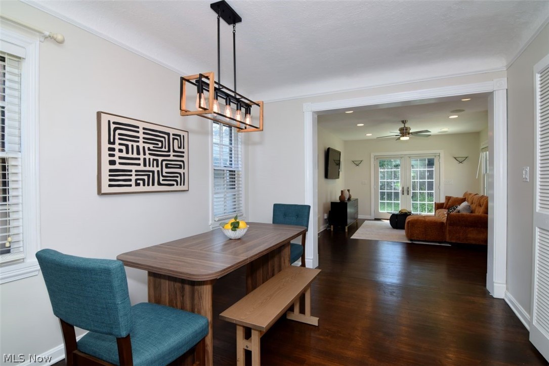 3806 Westwood Road University Heights, OH 44118 - Photo 6 of 41 Dining room featuring a modern linear chandelier, wood-finish flooring, and white window blinds