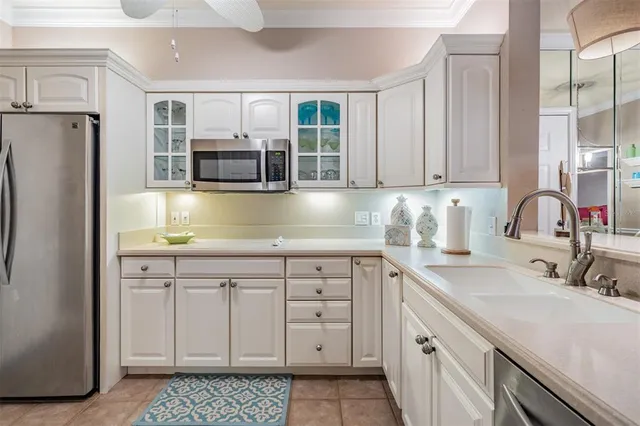 a kitchen with a sink cabinets and stainless steel appliances
