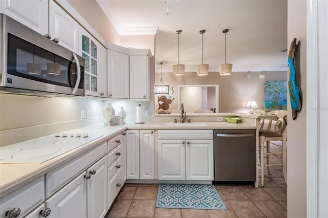a kitchen with cabinets appliances a sink and a counter top