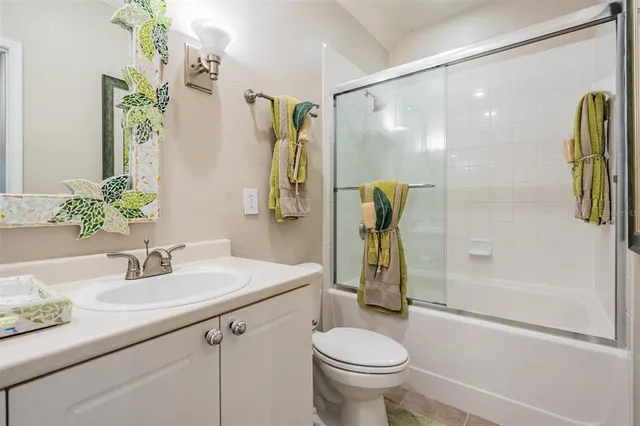 a spacious bedroom with a bed and a chandelier