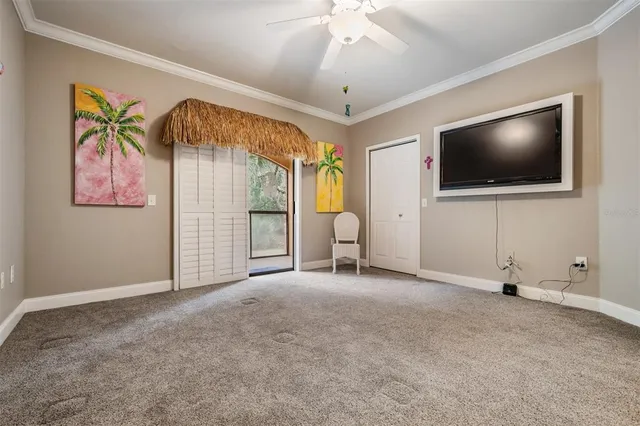 a porch with a table and chairs next to a yard