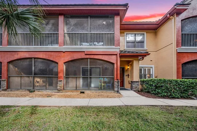 a view of a swimming pool with a patio and a backyard