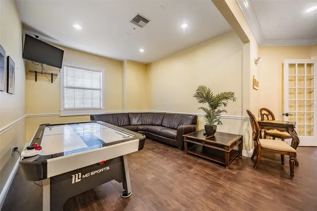 a room with pool table and windows