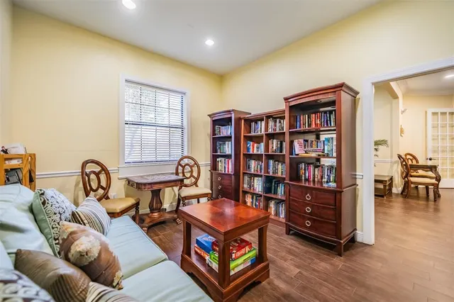 a room with pool table and windows