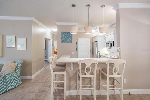 a view of a dining room with furniture and chandelier