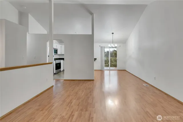 a view of a kitchen with wooden floor and a large window