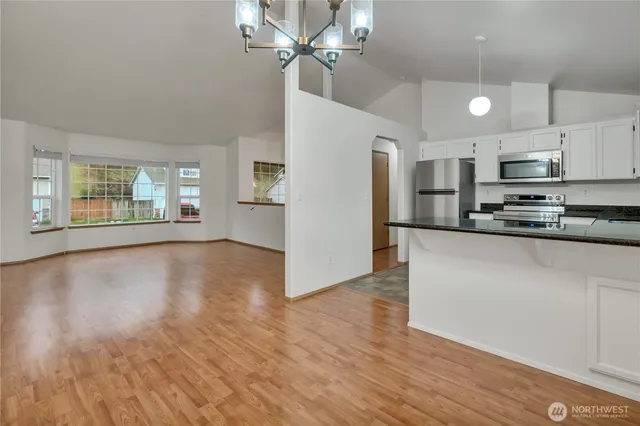 a view of kitchen with stainless steel appliances refrigerator oven and cabinets