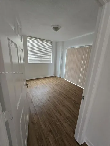 a view of a room with wooden floor and staircase