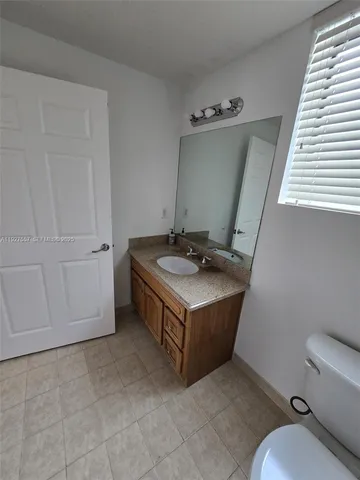 a bathroom with a sink a toilet and bathtub