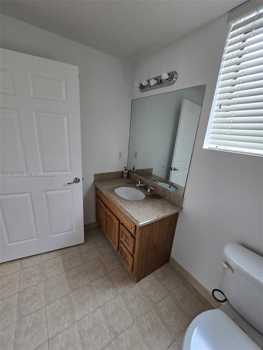 4242 Northwest 2nd Street, Unit 1614 Miami, FL 33126 - Photo 14 of 24 a bathroom with a sink a toilet and bathtub