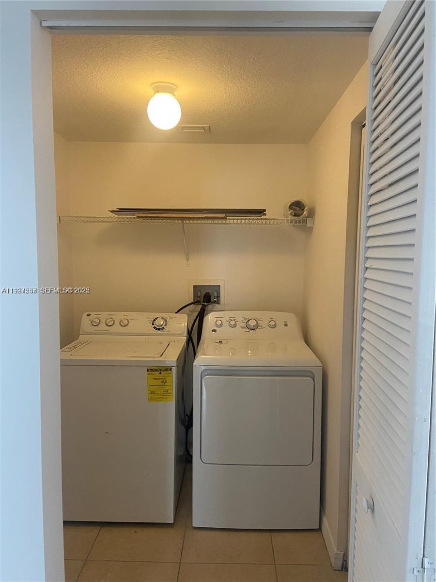 4242 Northwest 2nd Street, Unit 1614 Miami, FL 33126 - Photo 19 of 24 a utility room with dryer and washer