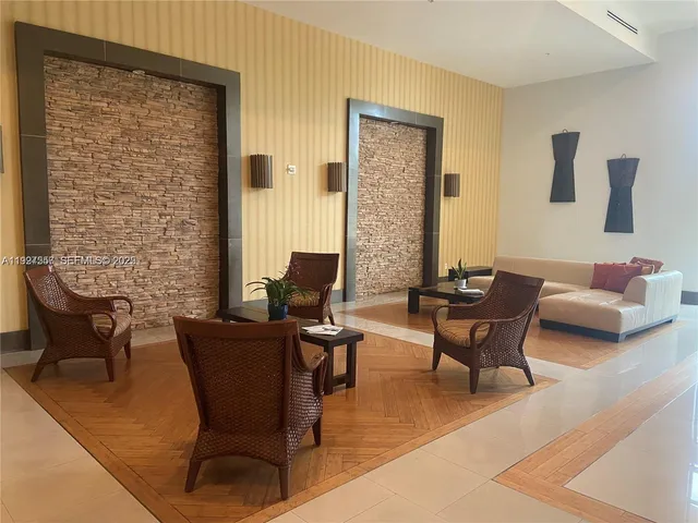 a view of a livingroom with lounge chair and a couch