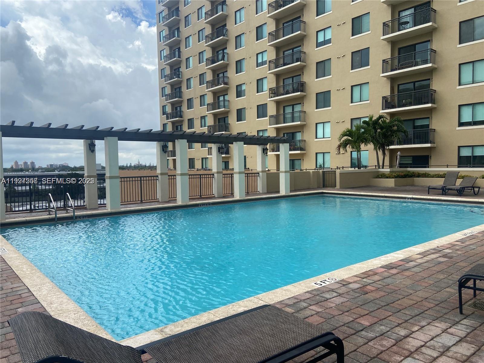 4242 Northwest 2nd Street, Unit 1614 Miami, FL 33126 - Photo 24 of 24 a view of swimming pool with outdoor seating