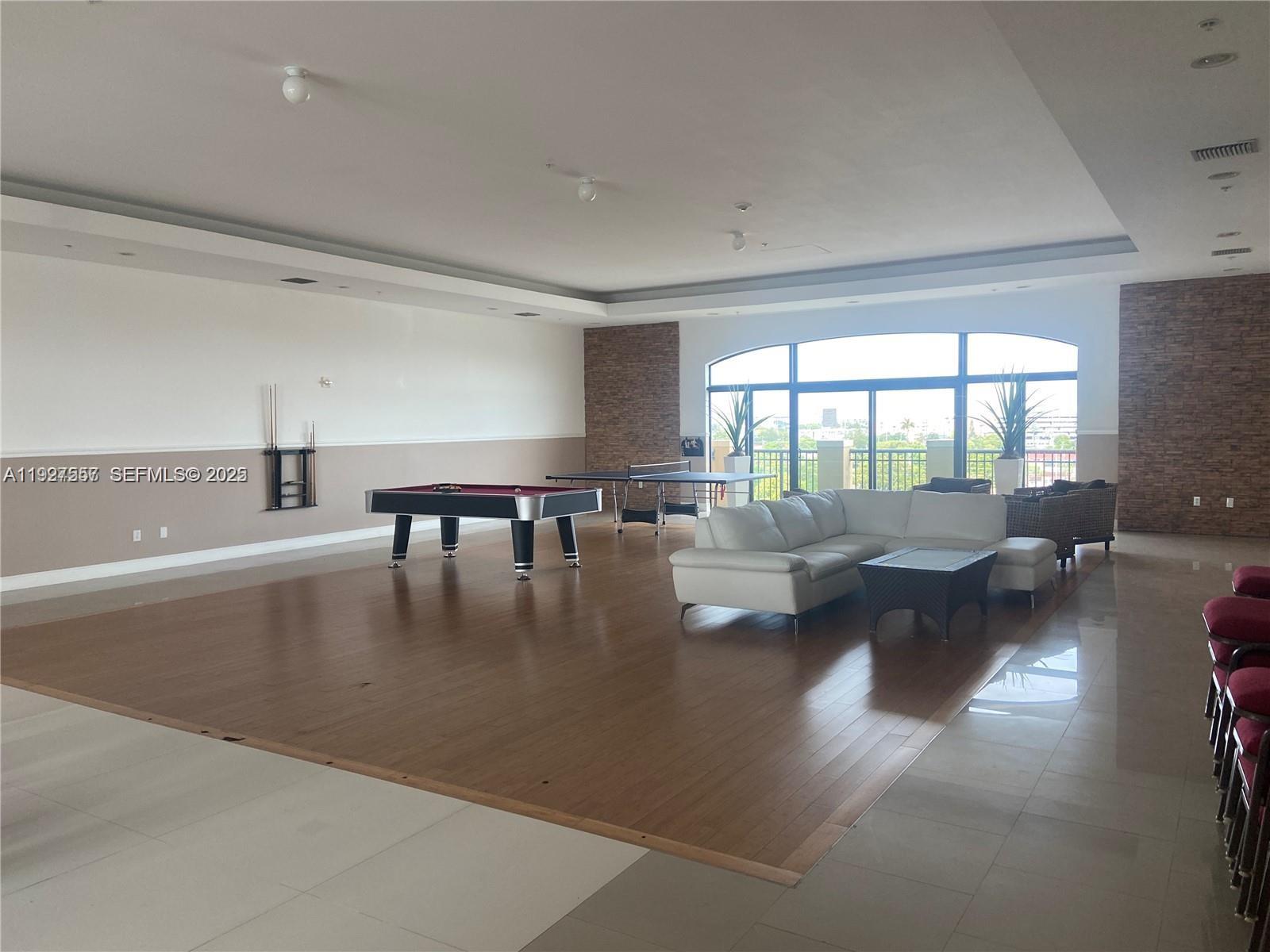 4242 Northwest 2nd Street, Unit 1614 Miami, FL 33126 - Photo 4 of 24 a lobby with furniture and floor to ceiling window