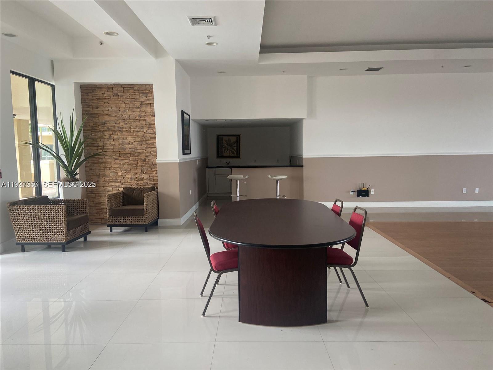 4242 Northwest 2nd Street, Unit 1614 Miami, FL 33126 - Photo 5 of 24 a dinning room with furniture and a fireplace