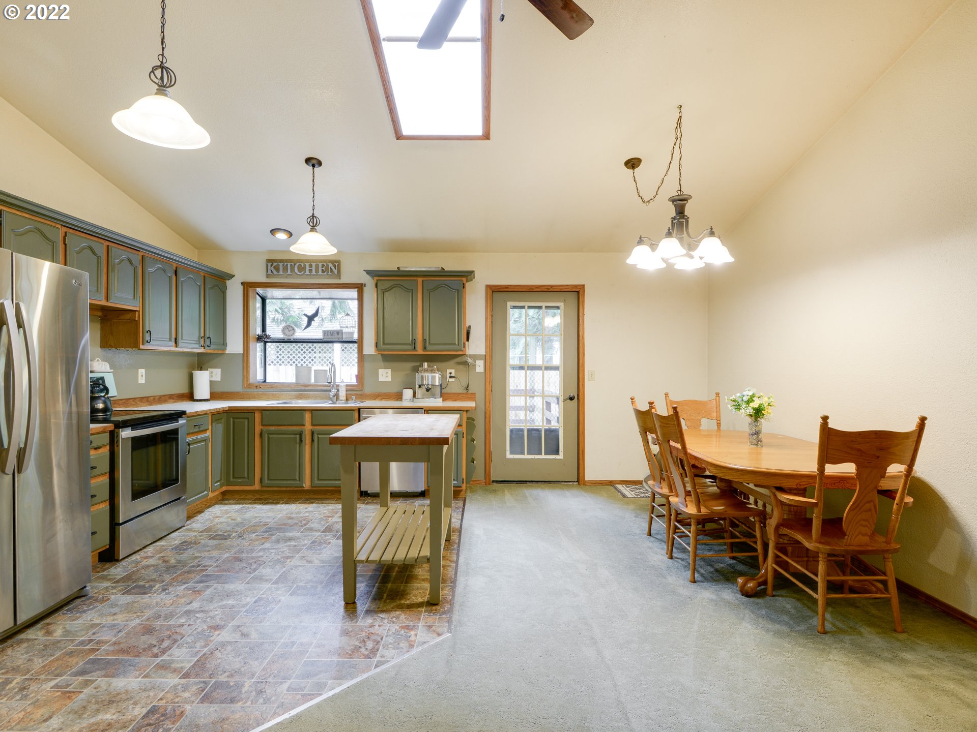 64911 East Sandy River Lane Rhododendron, OR 97049 - Photo 12 of 27 a large kitchen with a table and chairs