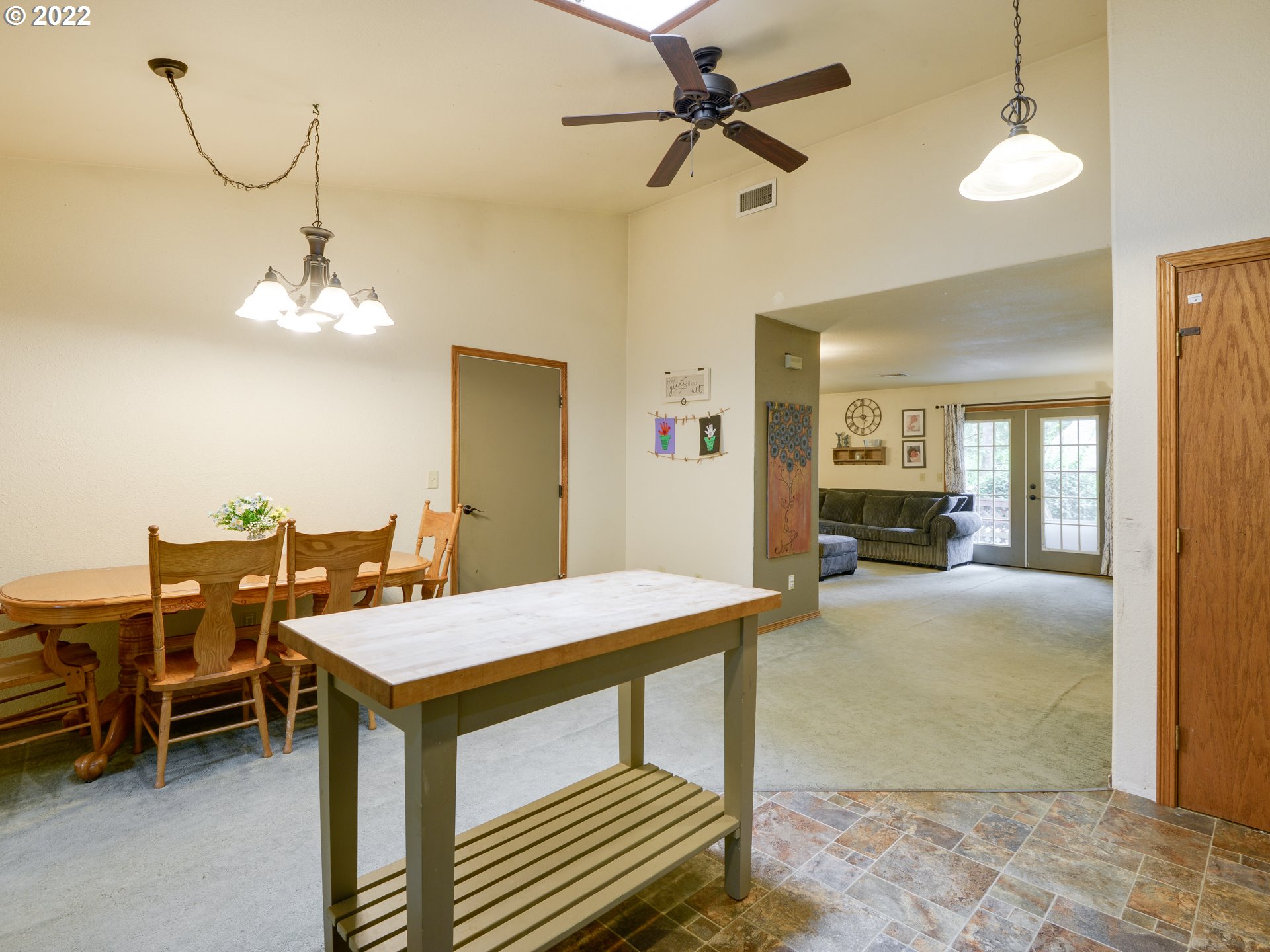64911 East Sandy River Lane Rhododendron, OR 97049 - Photo 13 of 27 a view of a dining room with furniture and a chandelier