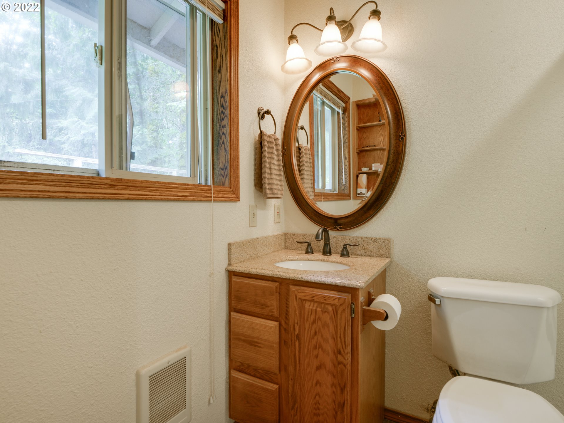 64911 East Sandy River Lane Rhododendron, OR 97049 - Photo 17 of 27 a bathroom with a toilet and a mirror