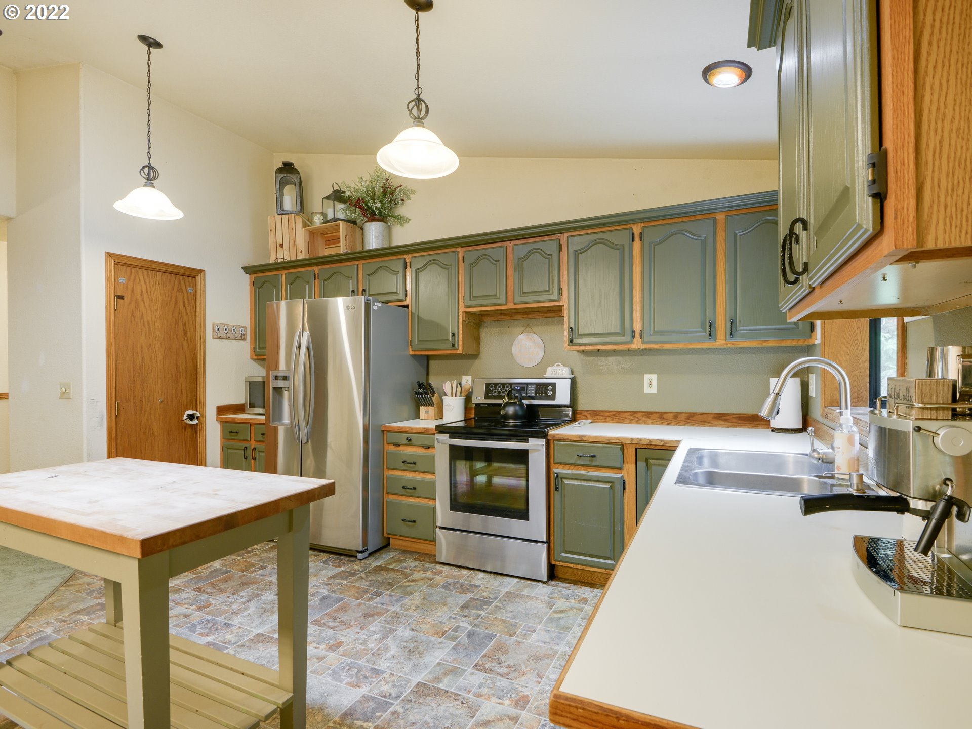 64911 East Sandy River Lane Rhododendron, OR 97049 - Photo 10 of 27 a kitchen with stainless steel appliances granite countertop a sink a stove and a refrigerator