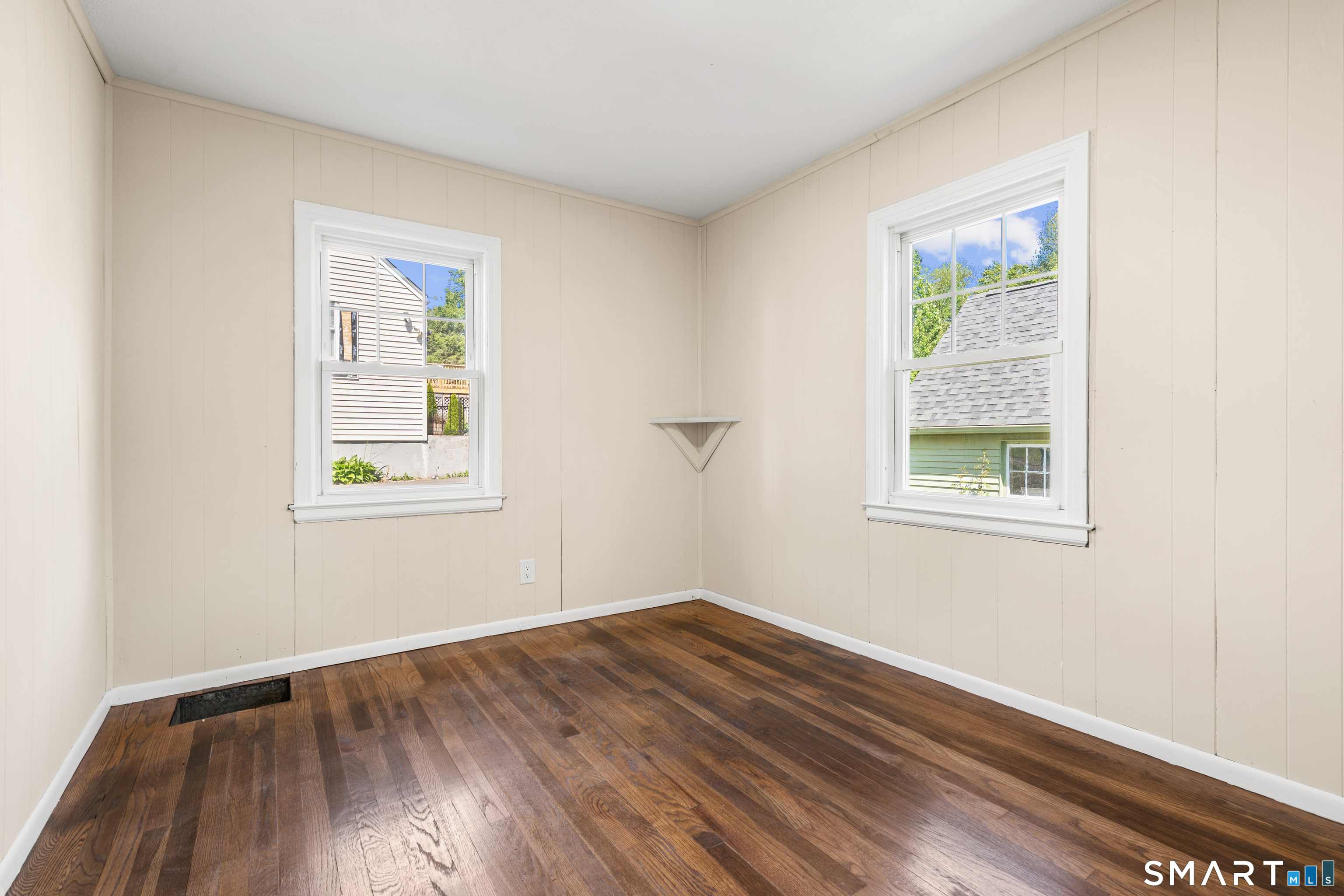 175 Moody Street Bristol, CT 06010 - Photo 18 of 28 an empty room with wooden floor and windows