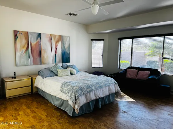 a bedroom with a bed and a large window