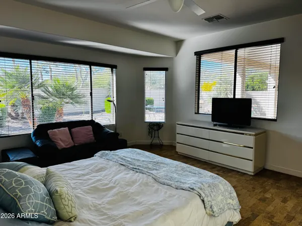 a bedroom with a bed and large window
