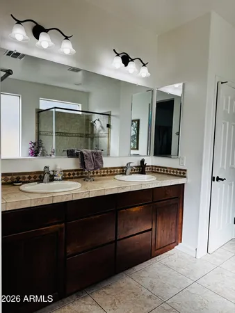 a bathroom with a sink double vanity and a mirror