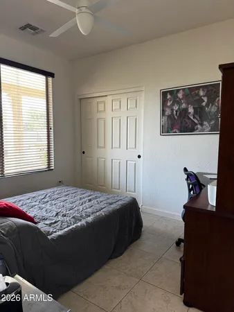 a bedroom with a bed and a window