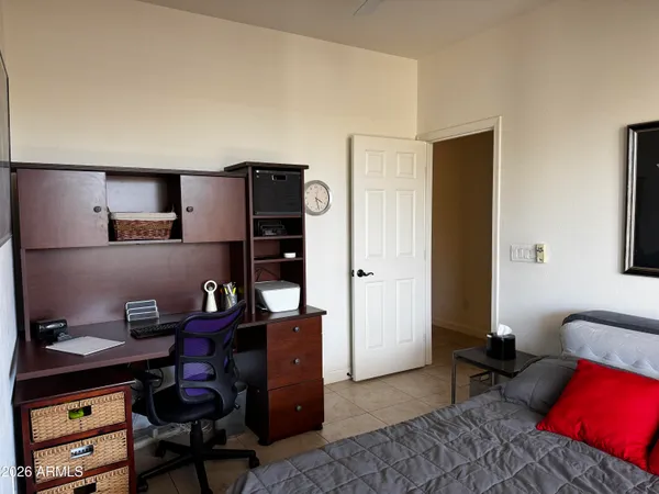 a livingroom with workspace and a couch