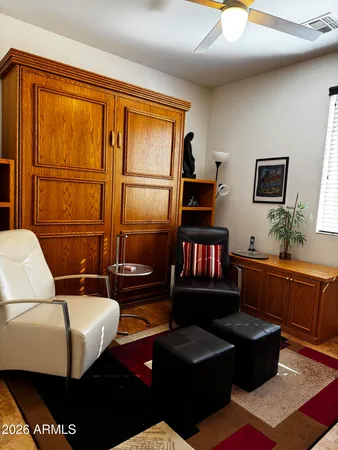 a living room with furniture a rug and a window