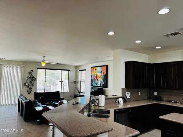 a living room with furniture a flat screen tv and a window