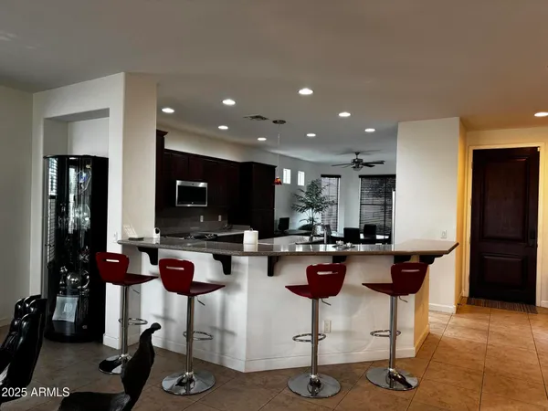 a kitchen with a dining table cabinets appliances and a counter