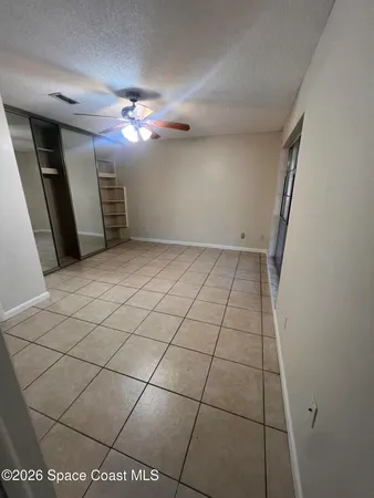 a view of a livingroom with a ceiling fan and window