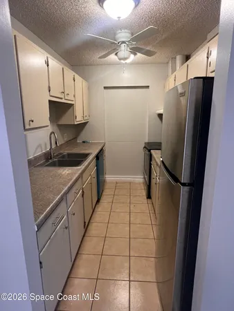 a kitchen with a refrigerator a sink and cabinets
