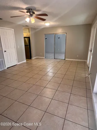 a view of a livingroom with a furniture and a ceiling fan