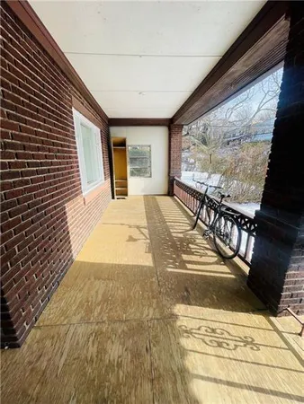 a view of a patio with table and chairs with wooden floor and fence