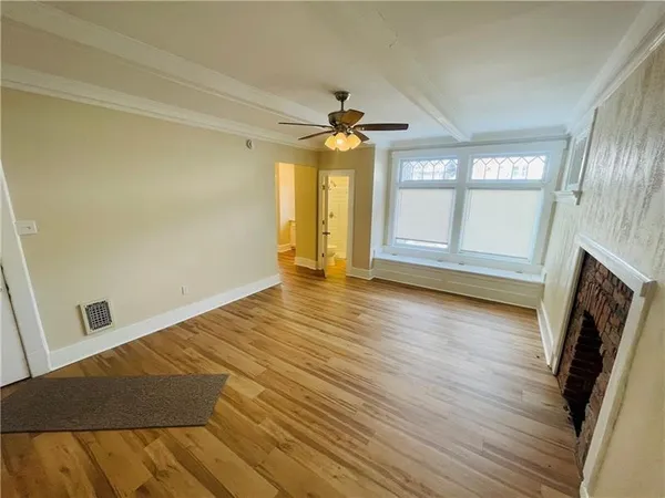 wooden floor in an empty room with a fireplace