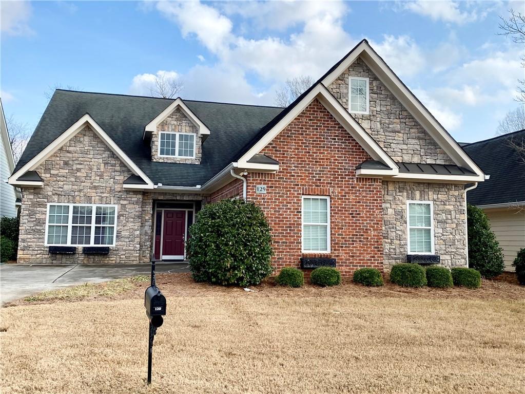 129 Maplecrest Lane Southeast Rome, GA 30161 - Photo 1 of 1 a front view of a house with a yard