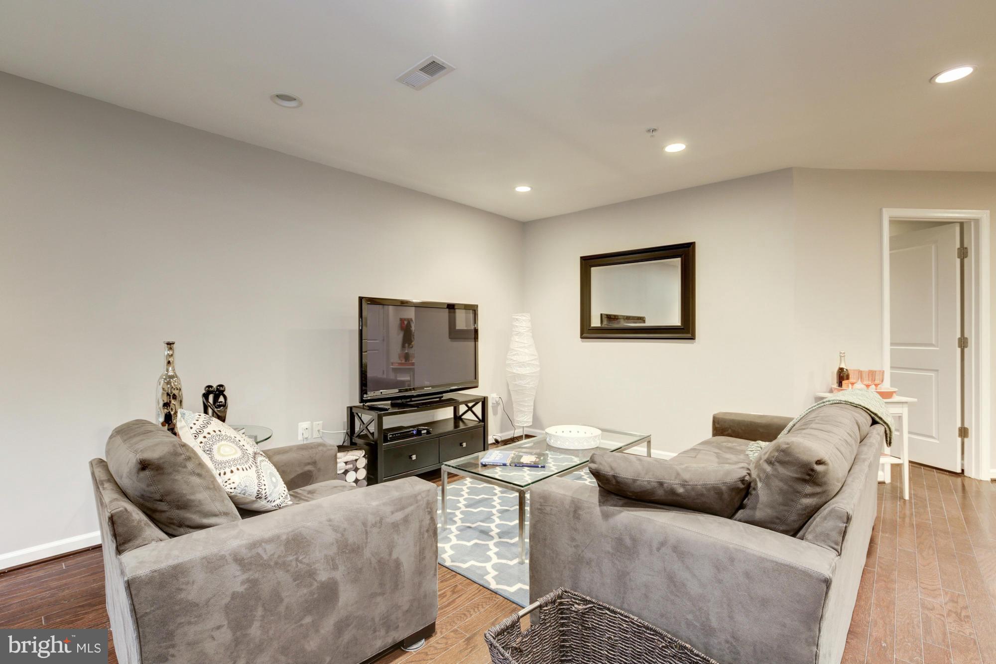 1845 Kalorama Road Northwest, Unit 1 Washington, DC 20009 - Photo 12 of 20 a living room with furniture and a flat screen tv