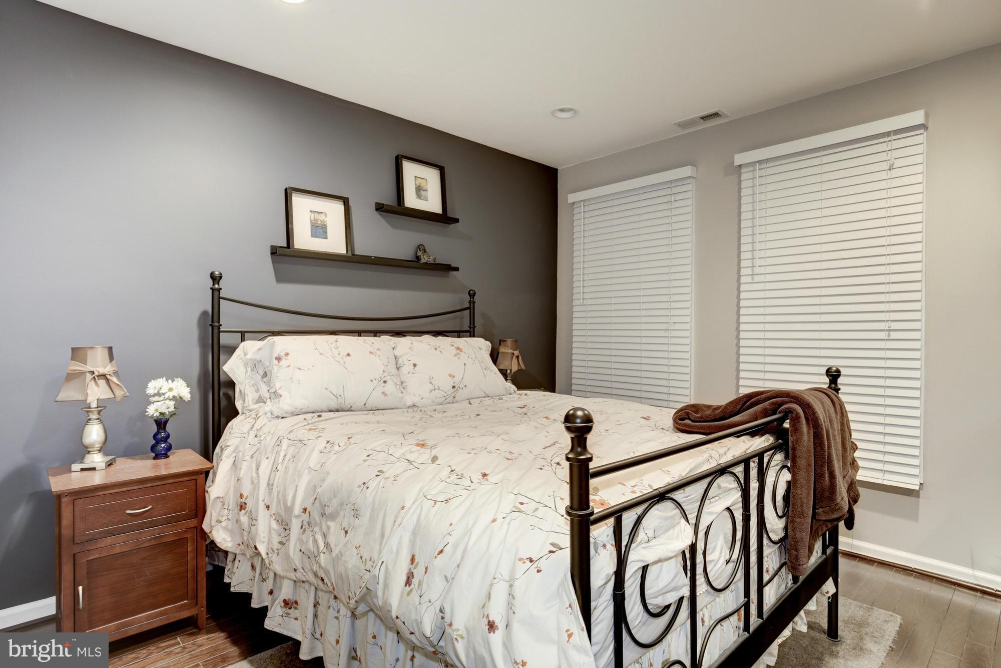 1845 Kalorama Road Northwest, Unit 1 Washington, DC 20009 - Photo 16 of 20 a bedroom with a bed and wooden floor