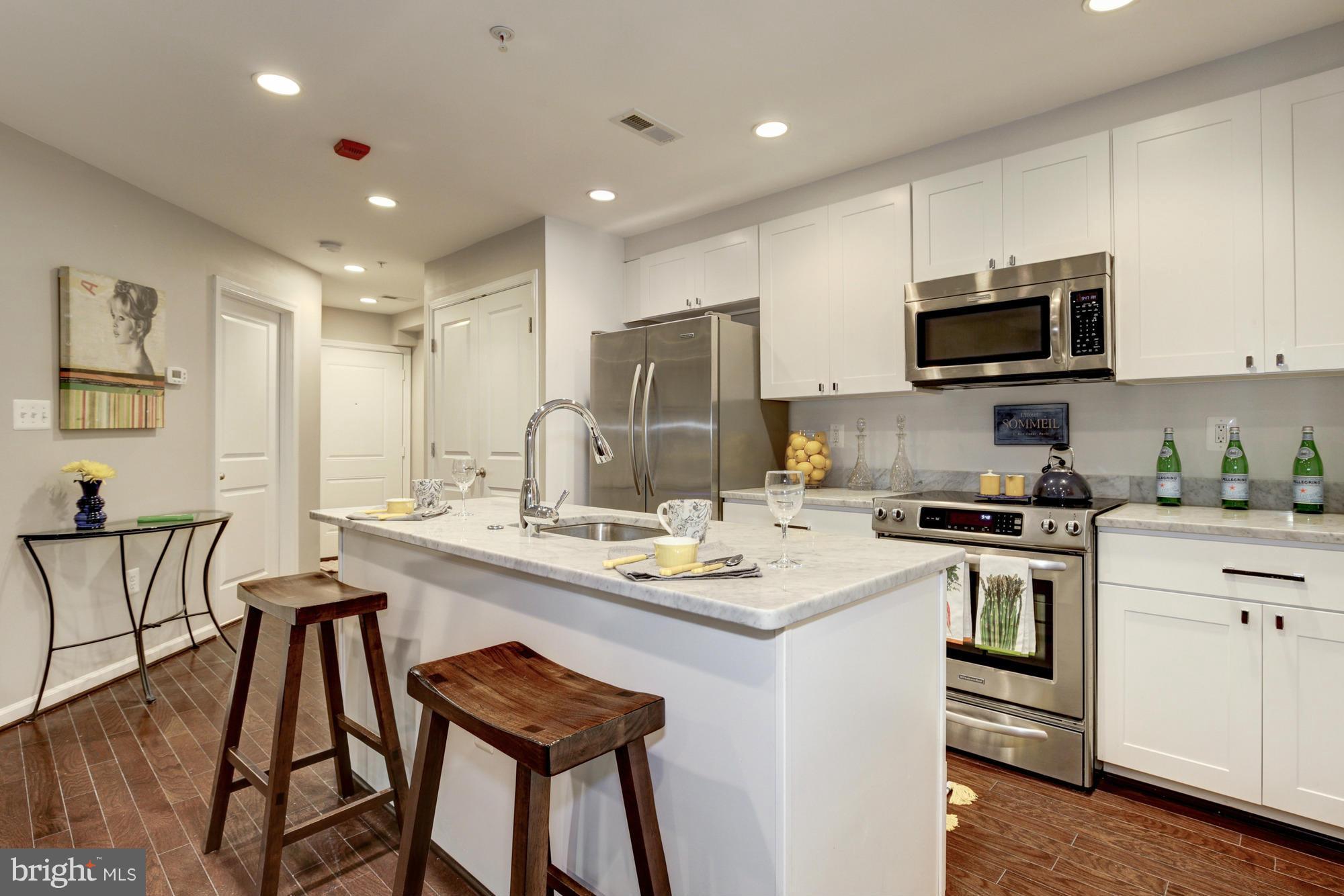 1845 Kalorama Road Northwest, Unit 1 Washington, DC 20009 - Photo 4 of 20 a kitchen with a stove a sink and a refrigerator