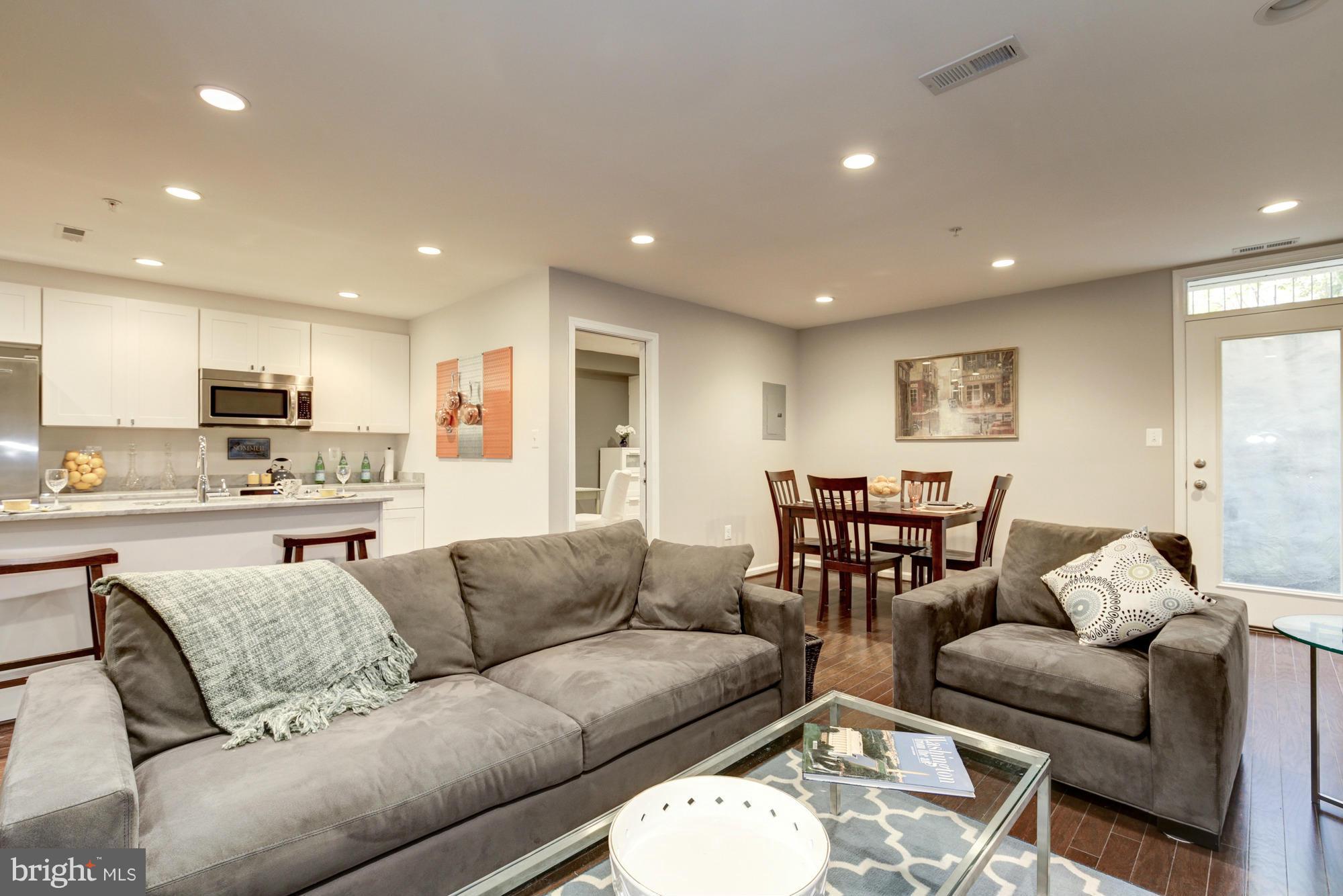 1845 Kalorama Road Northwest, Unit 1 Washington, DC 20009 - Photo 8 of 20 a living room kitchen with furniture and kitchen view