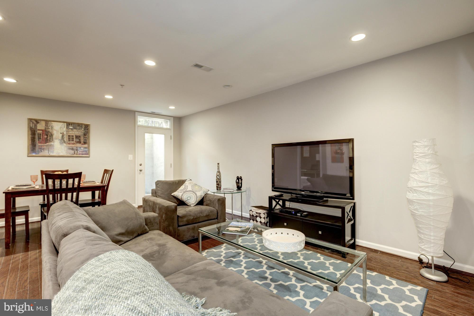 1845 Kalorama Road Northwest, Unit 1 Washington, DC 20009 - Photo 9 of 20 a living room with furniture and a flat screen tv