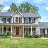front view of a brick house with a yard