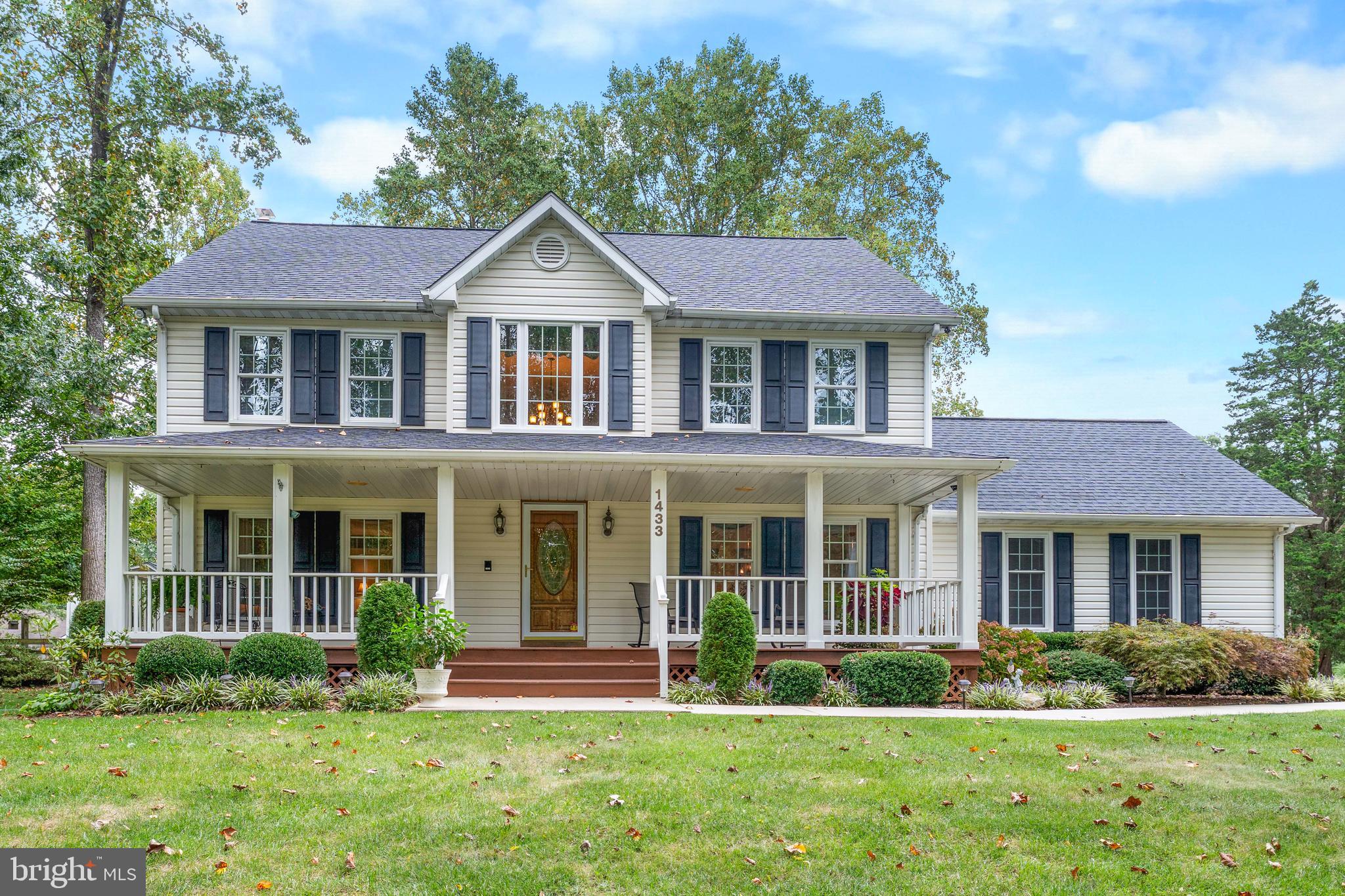 front view of a brick house with a yard