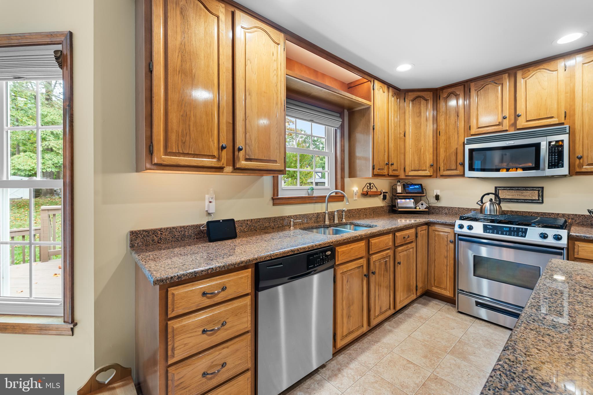 1433 Gilbert Road Arnold, MD 21012 - Photo 18 of 63 a kitchen with stainless steel appliances granite countertop a stove a sink and a microwave