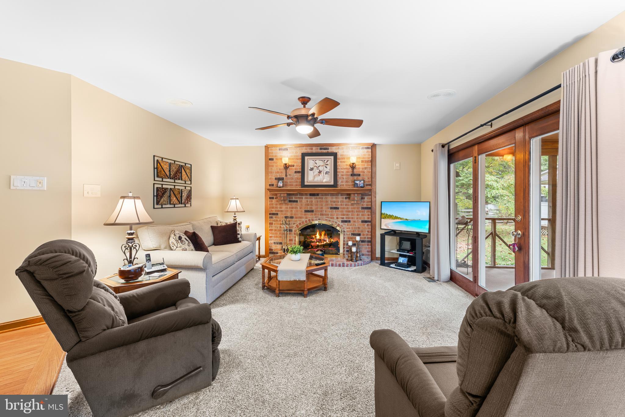 1433 Gilbert Road Arnold, MD 21012 - Photo 21 of 63 a living room with furniture two large windows a fireplace and a chandelier