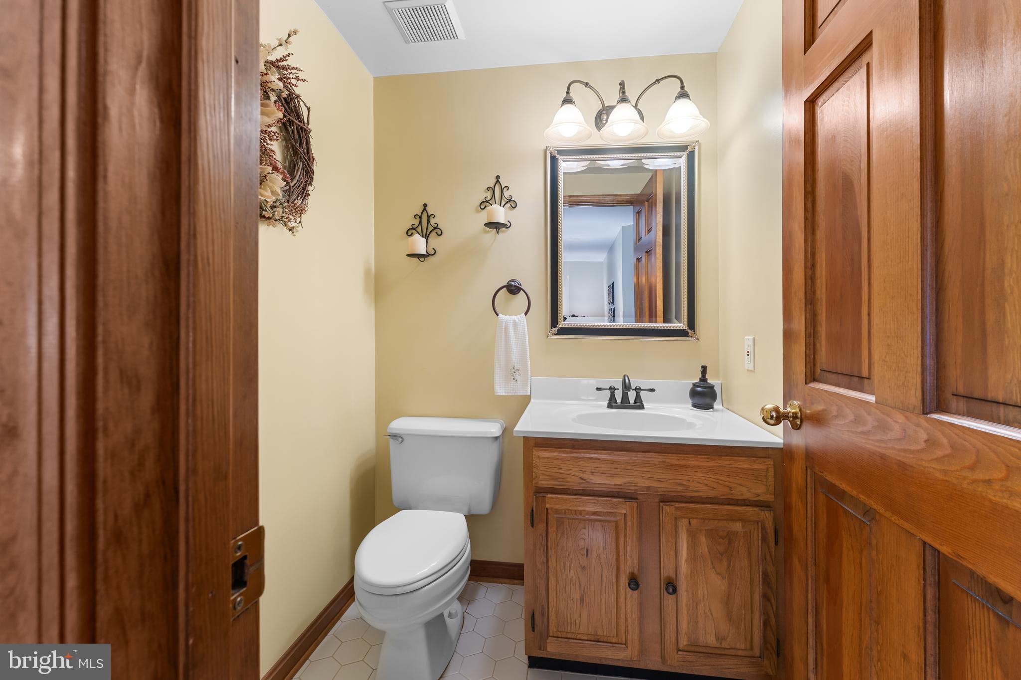 1433 Gilbert Road Arnold, MD 21012 - Photo 23 of 63 a bathroom with a toilet sink and mirror